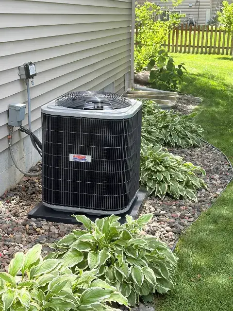Air conditioning unit surrounded by landscaping in Maple Grove, MN